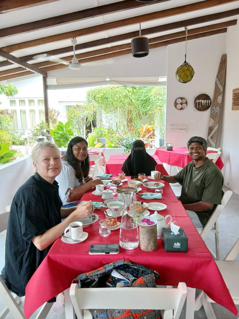 Dining at Carpaccio with the garden visible through the open terrace